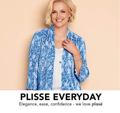 A female model, smiling, standing proudly, comfortable in her plisse top